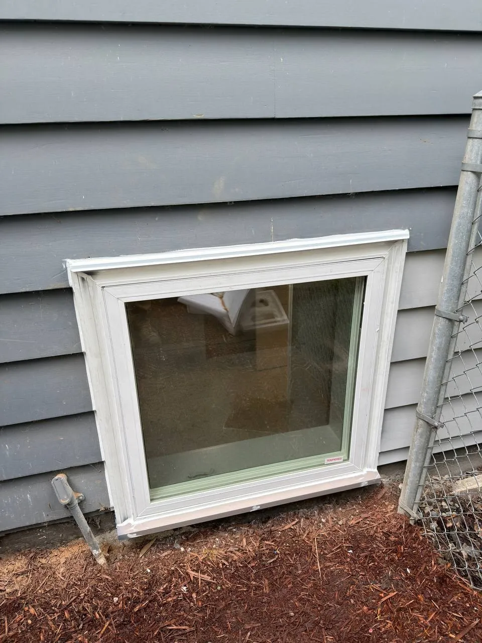 New basement window installed in siding