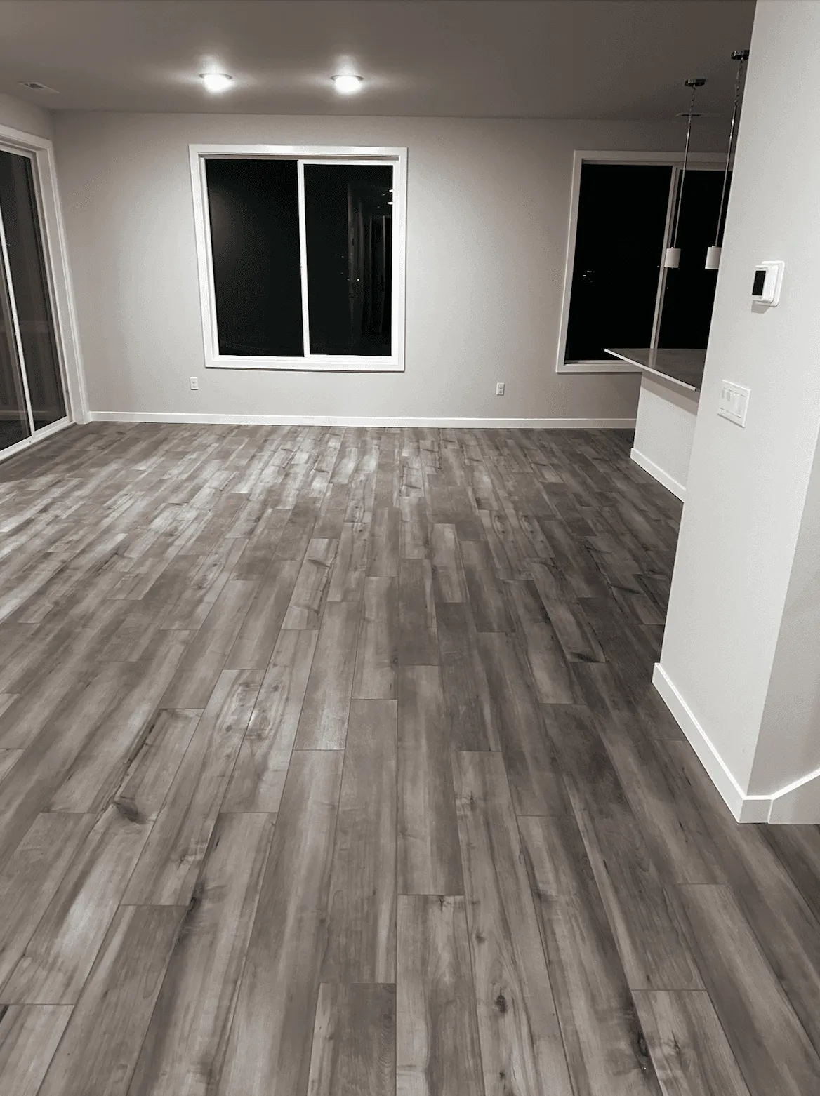 Gray wood-look vinyl plank in an empty living room