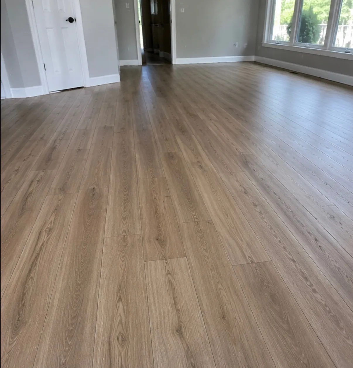 Wood-look luxury vinyl plank across an open living area