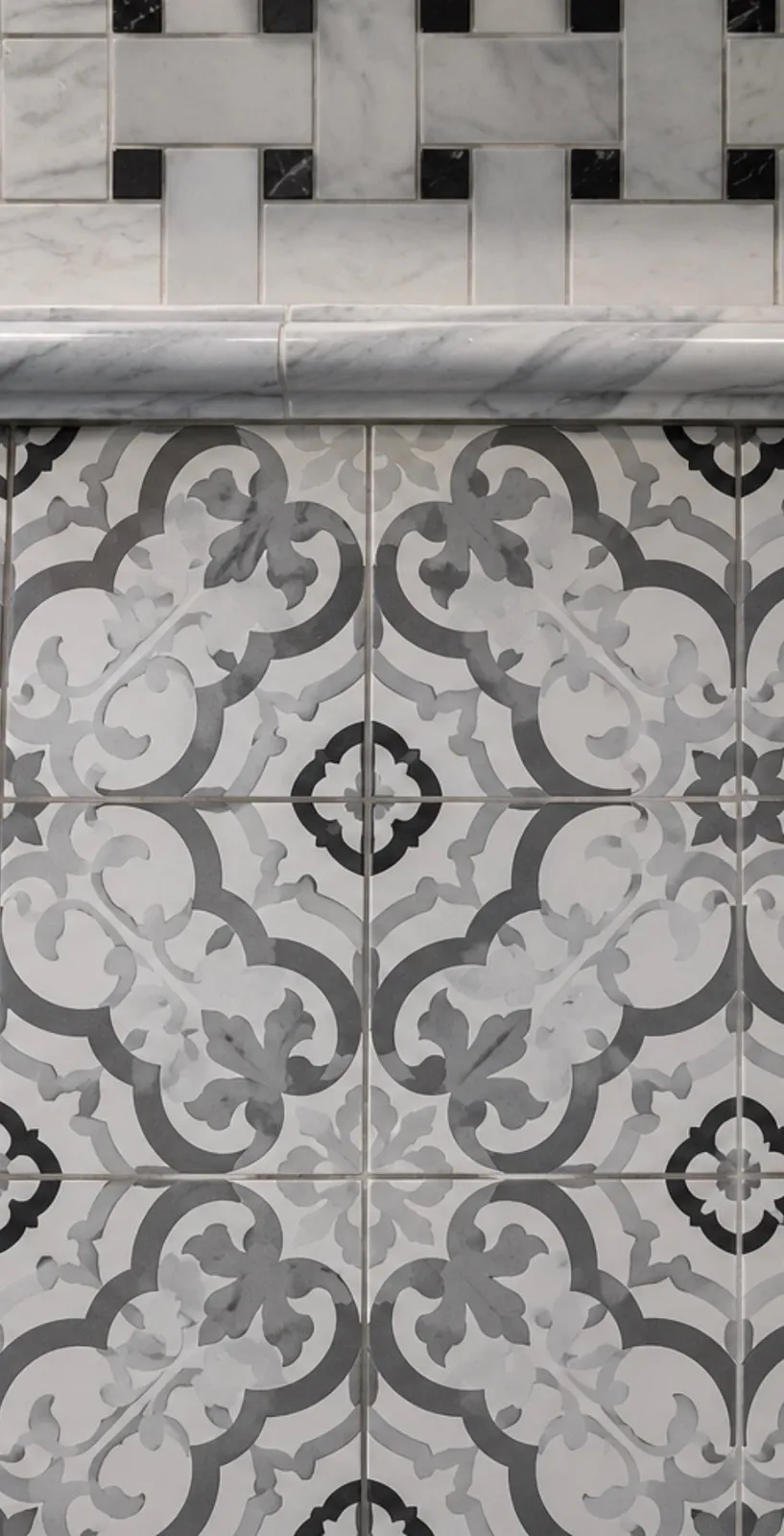 Gray and white patterned tile floor below a basketweave border