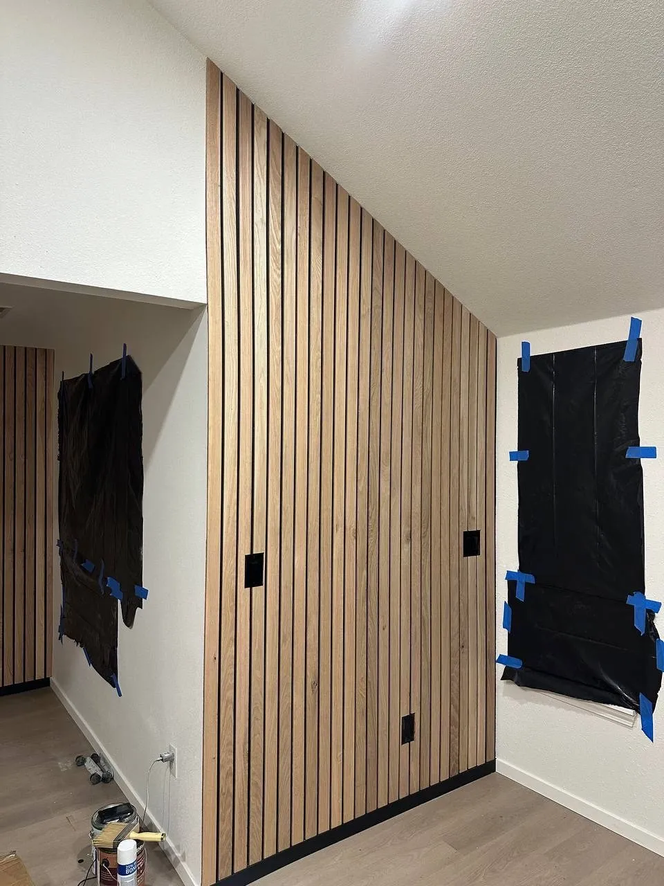 Wood slat accent wall installed during an interior finish project